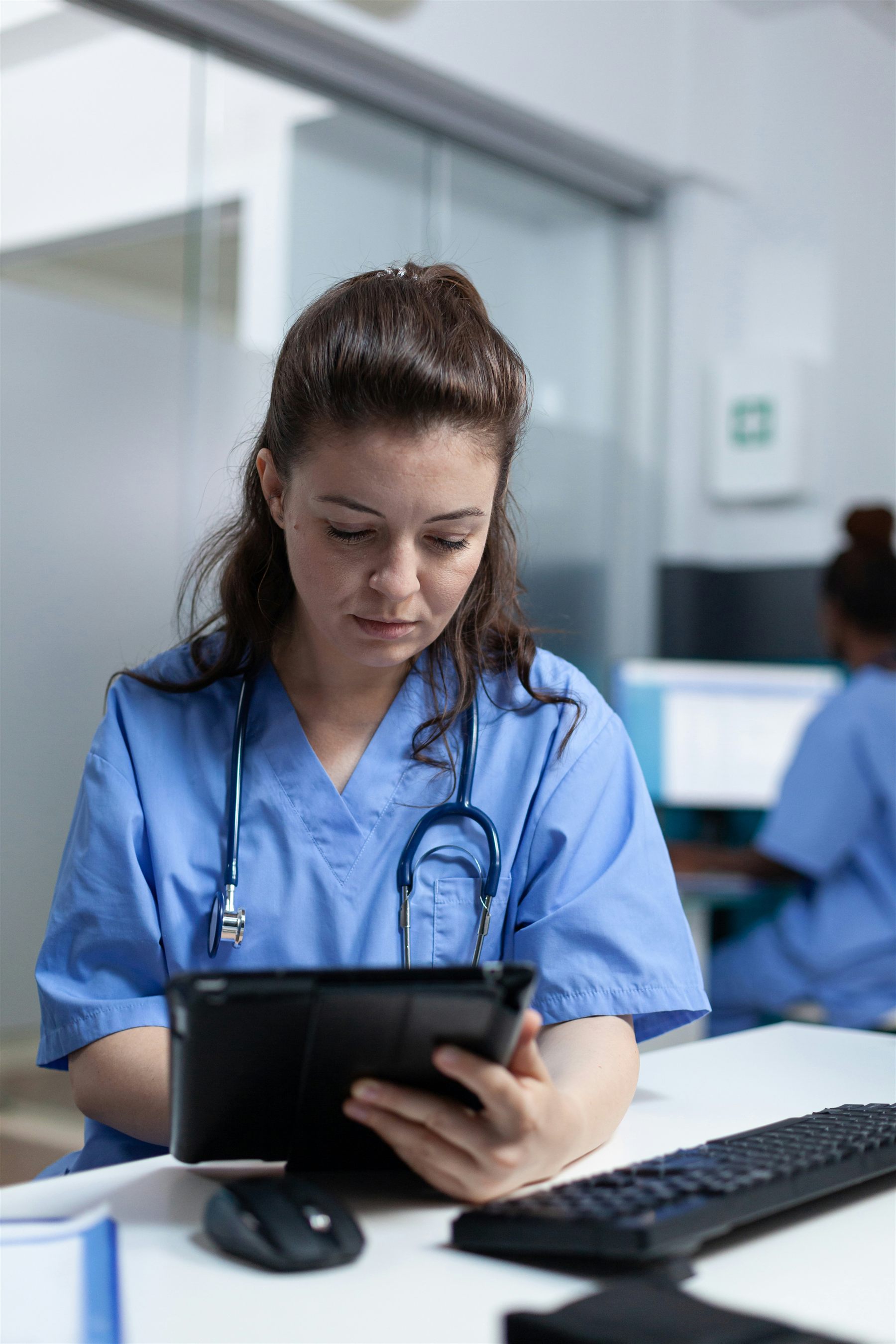 A nurse reviewing clinical notes